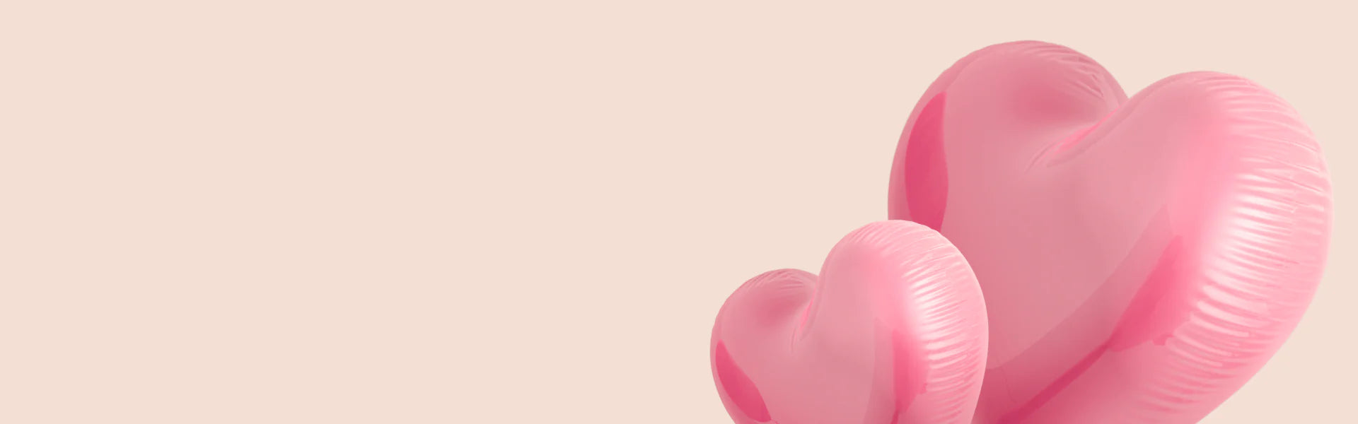 A pink balloon in the shape of a heart.