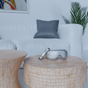 A wooden table with a Renpho Eyeris Smart Eye Massager on it and a plant. (A)