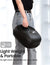 A woman holding a black bag with the words "Renpho Shiatsu Foot Massager Machine with Heat.