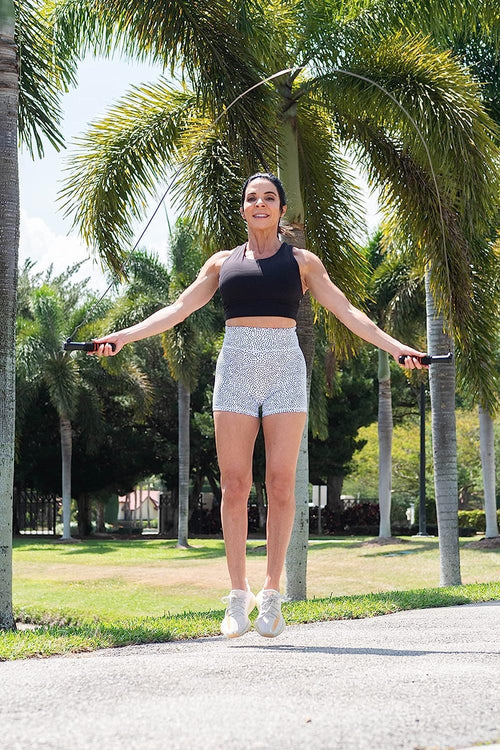 A woman using the Renpho Bundle (Smart Jump Rope 1 and Smart Tape Measure BMF01) in a park.