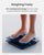 A person's feet on a Renpho Elis 2X Smart Body Scale with the words 'weighting freely' displayed on a VA display. (A)