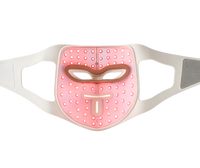 Inside of the LED light therapy mask with its 280 LEDs glowing red, head straps laid flat