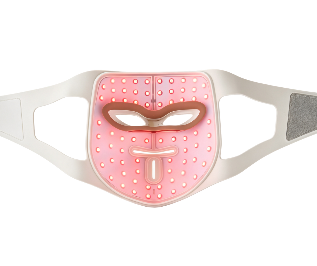 Inside of the LED light therapy mask with its 280 LEDs glowing red, head straps laid flat