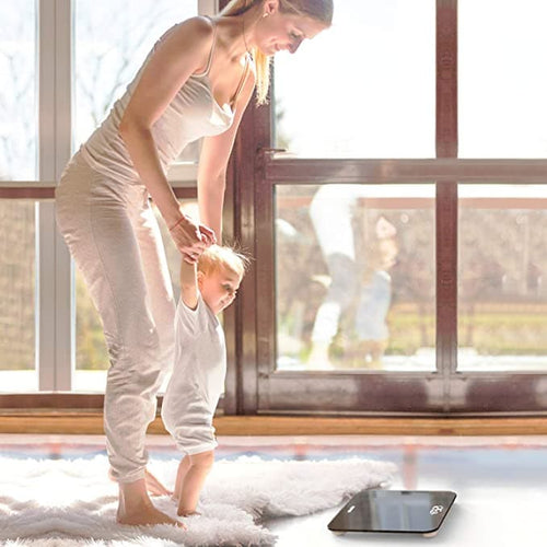 A woman and a baby using the Renpho Core 1S Body Scale for their fitness and health journey.